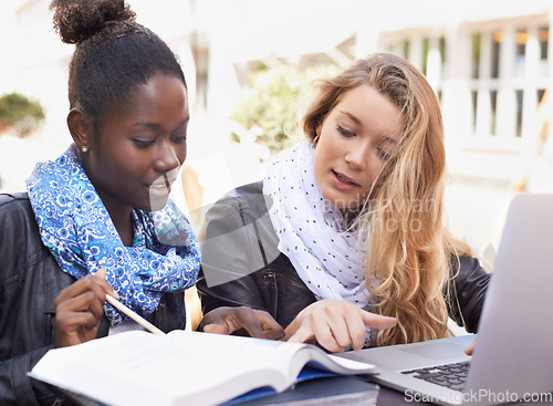 Image of Woman, students and studying with textbook in collaboration for assignment, project or higher education in city. Women friends working together to study, ideas or work on group project in urban town