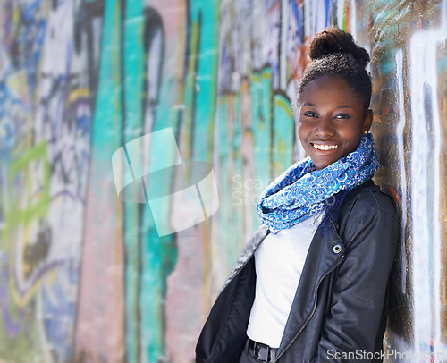 Image of Portrait, urban fashion and black woman at wall with smile, graffiti and mockup standing at street art. Happiness, youth and happy face of gen z model in African city with streetwear and sunshine.