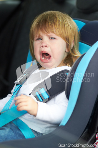 Image of Sad, crying and portrait of baby in car seat for fear, uncomfortable and travel safety. Security, transportation and journey with upset toddler for vacation trip, frustrated and protection