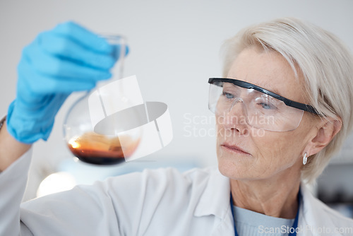 Image of Woman, chemical test and science research or medical analysis in a laboratory for investigation or study. Face of a scientist person with liquid, goggles and flask for future medicine or innovation