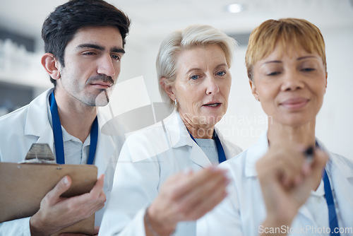 Image of Doctor, team and writing for healthcare planning, schedule or brainstorming together at hospital. Group of doctors in meeting, collaboration or teamwork for medical strategy, tasks or plan at clinic