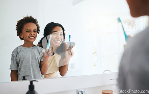 Image of Teaching, mama and son brushing teeth, wellness and cleaning mouth at home, bathroom and smile. Family, female parent and mother with male child, kid and boy with reflection, health or dental hygiene