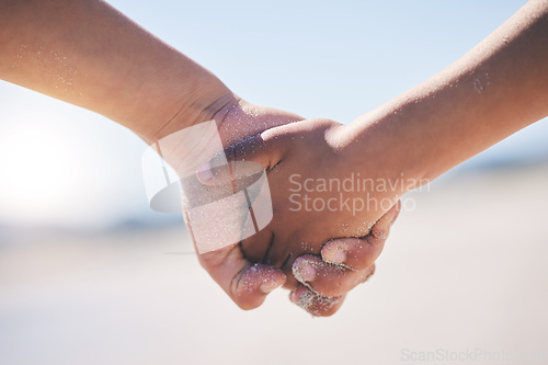 Image of Love, unity and couple holding hands at a beach with trust, solidarity and commitment in nature. Hand, care and man with woman on romantic walk at the sea, sweet and bonding while traveling together