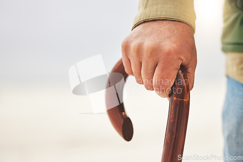 Image of Hand, senior man with disability and cane or walking stick for support. Injury or osteoarthritis, physical therapy or rehabilitation and elderly patient holding a wooden walk aid in closeup on mockup