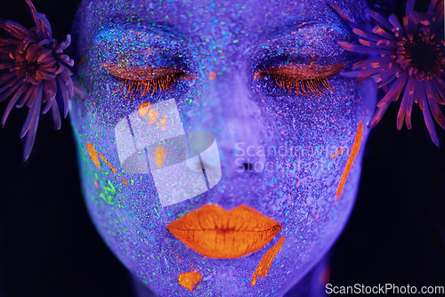 Image of Creative, face and woman with neon paint in studio for art freedom, fantasy or colorful aesthetic. Creativity, artistic and closeup of female model with facial psychedelic makeup by black background.