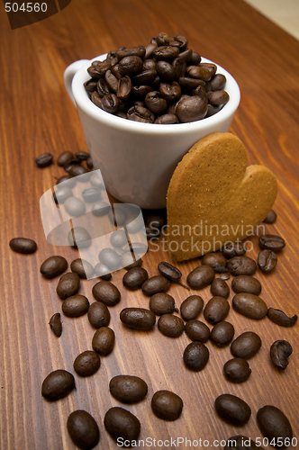 Image of Gingerbread cookie heart in front of coffee cup