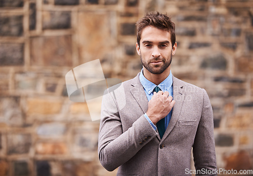 Image of Business man, portrait and city wall with fashion, confidence and success in entrepreneurship. Young businessman, executive and suit in urban street, road or side walk with focus, style and outdoor