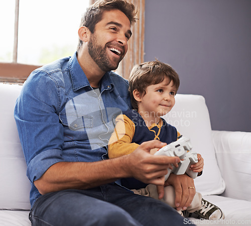 Image of Happy, father and son with controller, video game and happiness at home, bonding and quality time. Family, dad or male child on a couch, loving or playing online games, joy and technology in a lounge