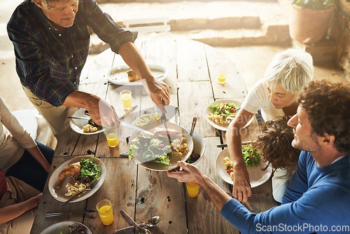 Image of Food, party and share with family at lunch from above for health, bonding and celebration. Vacation, social and event with parents and children eating together for dining, generations and wellness