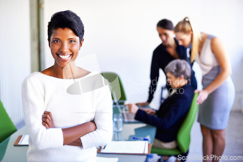 Image of Happy, confidence and portrait of a businesswoman in a meeting in a modern corporate office. Happiness, success and professional female manager standing with crossed arms in the workplace boardroom.