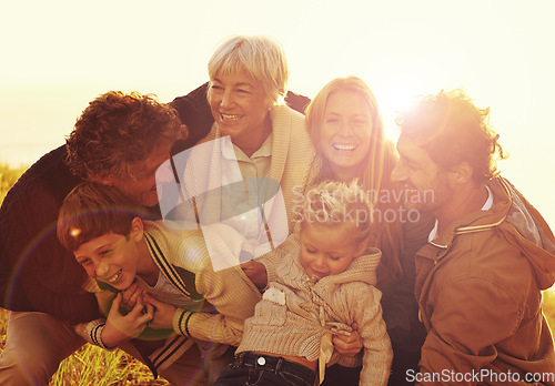 Image of Happy, love and big family in nature at sunset hugging, bonding and spending quality time together. Happiness, smile and children posing with their parents and grandparents in outdoor field at dusk.
