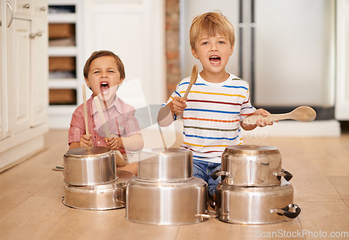 Image of Children, playing and pots for music or noise in family home or kitchen for happiness, fun and portrait. Male kids or friends together for a portrait, play and drum instrument for freedom and fantasy
