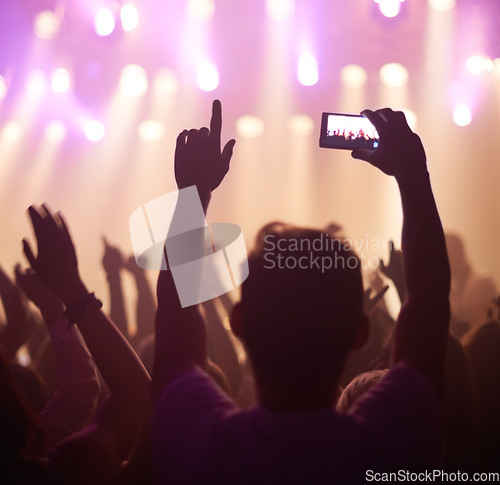 Image of Fan, phone filming and band on stage with excited audience, lighting colors and music performance on video. Smartphone screen, photography and festival crowd at night and concert, event or party