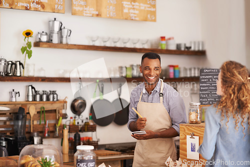 Image of Barista, counter and woman with order at cafe with smile, notes and service for good customer experience. Waiter, writing and lady with choice, decision or pick from menu in restaurant, deli or diner