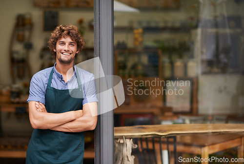 Image of Welcome, arms crossed and portrait of man at restaurant for small business, coffee shop and waiter. Entrepreneur, happy and smile with male barista at front door of cafe for diner and food industry