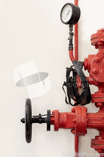 Image of Fire station, hydrant or pump for emergency with faucet, valve or gauge to control water pressure. Metal firefighter equipment, health and safety tools for public services by wall background for help