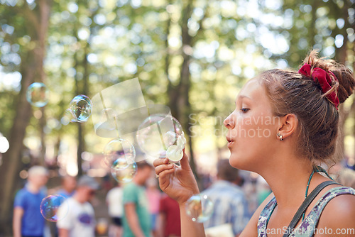 Image of Party, bubbles and music with woman at festival in forest for celebration, summer and performance. Carnival, culture and concert with female in nature for dancing, rave show and techno event