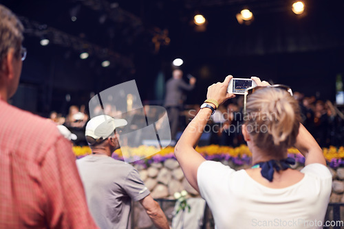 Image of Music, camera and party with woman at festival for stage picture, social media and summer. Techno, celebration and rave with female photographer in crowd for carnival, energy and rock event