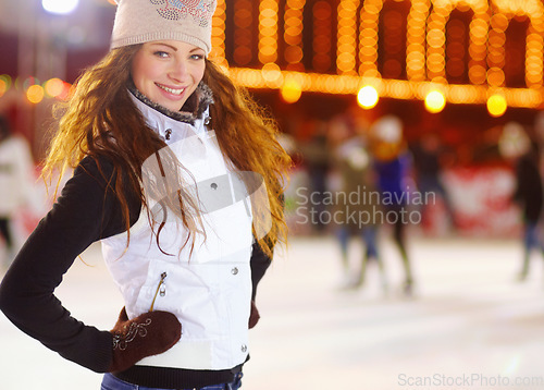 Image of Woman, ice skating portrait and happiness in night for workout, training and exercise on winter holiday. Girl, skate rink and happy for sports, outdoor and fitness with excited face for vacation