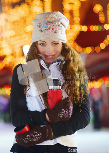 Image of Woman, ice skating and outdoor portrait with coffee in night winter holiday, training or exercise. Girl, vacation and happiness for sport, skate or fitness with excited face for drink, matcha or coco