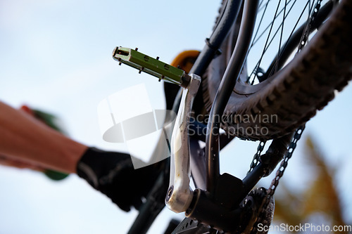 Image of Closeup, bicycle and low angle with wheel, chain and pedal for sport, fitness and workout in nature. Below mountain bike, tire and outdoor for race, sports adventure or eco friendly transportation