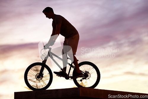 Image of Silhouette, sunset and cycling with man on bicycle for sports, adventure and fitness. Action, exercise and health with male cyclist riding on bmx bike for journey, urban or carbon neutral with mockup