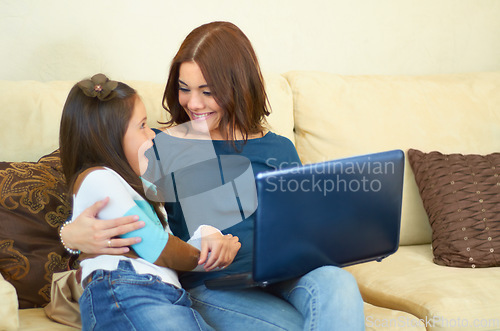 Image of Love, hug and mother with her child on a laptop while relaxing, talking and bonding on sofa. Happy, smile and young mom embracing girl kid while browsing on social media with computer in living room.