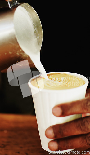 Image of Milk, coffee and hands of barista in cafe for cappuccino, restaurant and shopping. Retail, morning and espresso with closeup of man and pouring in cup for drink, latte art and preparation in store