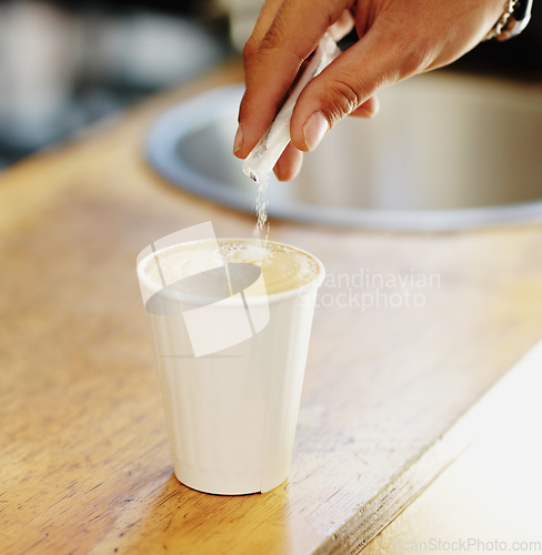 Image of Sugar, coffee and hands of person in cafe for cappuccino, restaurant and shopping. Retail, morning and espresso with closeup of man and pouring in cup for drink, latte art and preparation in store