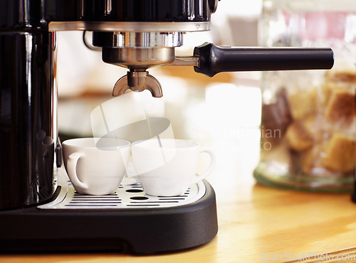 Image of Coffee, cups and machine on table in cafe for cappuccino, latte or hot drink. Restaurant, electrical appliance and caffeine mug for making or brewing espresso in retail shop or small business.