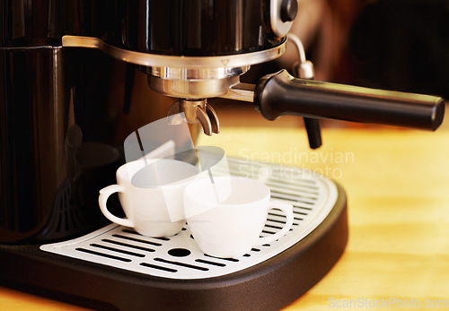 Image of Coffee maker, cups and machine on table in cafe for cappuccino, latte or hot drink. Restaurant, electrical appliance and caffeine cup for making or brewing espresso in retail shop or small business.