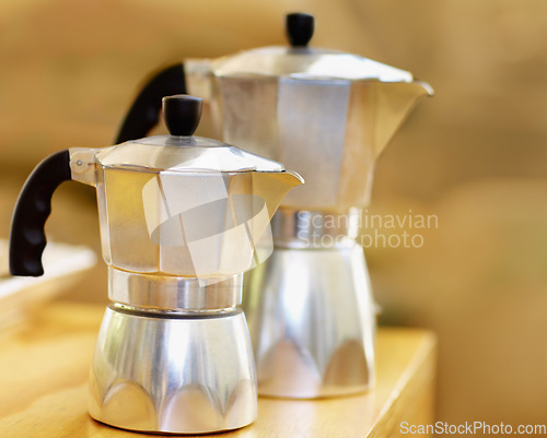 Image of Coffee, espresso and hot drink boiler for brewing fresh morning beverages or traditional Italian style moka pot for caffeine. Kitchen, appliance and tea making on table or metal household equipment