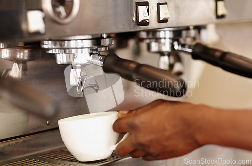 Image of Hand, woman barista using coffee machine and expresso or latte being made. Closeup, female waiter working in restaurant or cafeteria and cup with brewing process making a hot drink or beverage