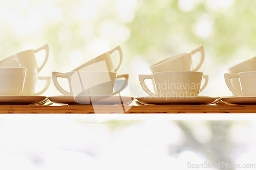 Image of Collection, tea or coffee mug closeup and porcelain cup with plate on window shelf with background mockup. White, ceramic and breakfast catering service set for party and cafe, hotel or restaurant