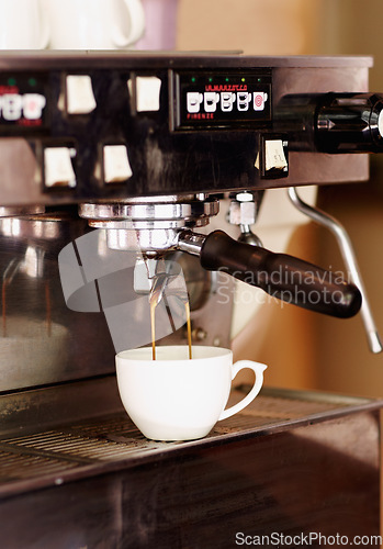 Image of Pouring coffee, mug and machine in cafe for espresso, latte beverage or hot drink. Restaurant, electrical appliance and caffeine cup for making or brewing cappuccino in retail shop or small business.