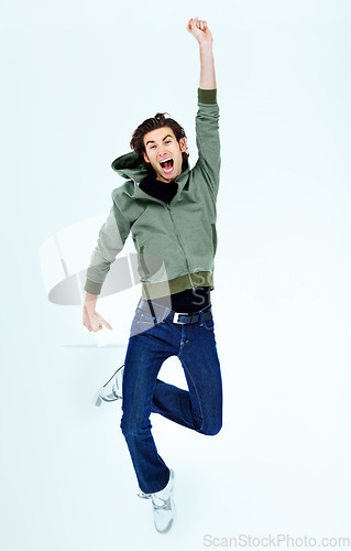 Image of Portrait, victory and man with a smile, winning and cheerful guy isolated against a studio background. Face, male person and human jumping, happiness and winner with joy, wow and freedom with energy