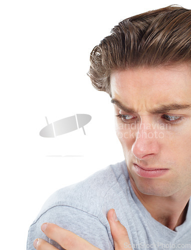 Image of Shoulder pain, injury and a man looking unhappy in studio isolated on a white background for recovery. Medical, anatomy and accident with a handsome young male person holding his joint in discomfort