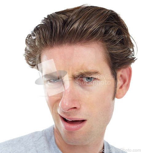 Image of Confused, closeup and portrait of man in studio for frustrated, disgusted and doubt. Goofy, displeased and unhappy with face of male isolated on white background for wow, funny and crazy expression