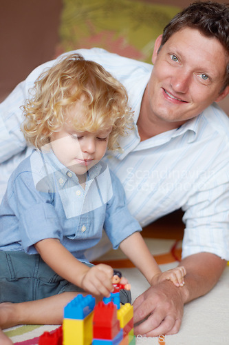 Image of Father relax with boy child, building blocks with toys for development and growth, playing together while at home. Family, man bonding with kid and learning, educational play time in portrait