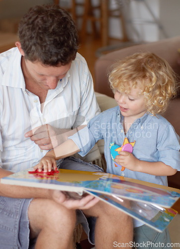 Image of Man with boy child, reading book for education and development, spending quality time together at home. Family, teaching and learning with father and kid bonding, picture story with toys for growth