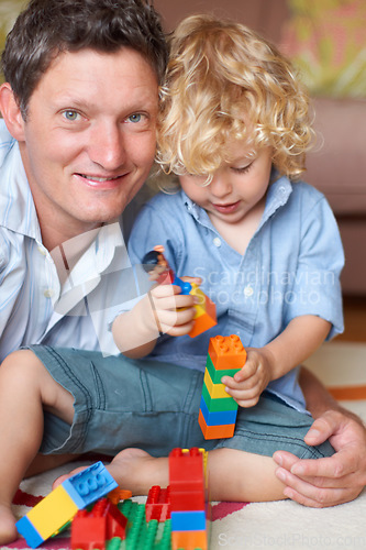 Image of Father is happy with boy child, building blocks and toys for learning and development with educational play time. Education, growth and playing together, man smile in portrait with kid at home