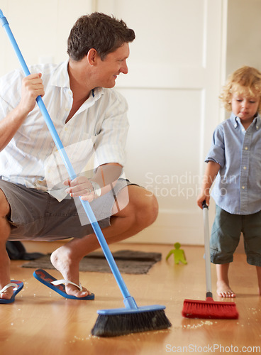 Image of Man is cleaning with boy child, sweeping with broom and help with mess on floor while at home together. Hygiene, chores and house work with man teaching kid to sweep and helping with crumbs on ground