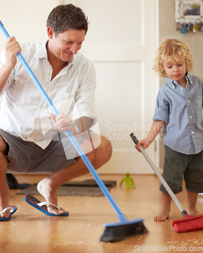 Image of Man is cleaning with boy kid, sweeping with broom and help with mess on floor while at home together. Hygiene, chores and house work with man teaching child to sweep and helping with crumbs on ground