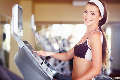 Image of Woman, gym portrait and treadmill with smile, start button and happy for fitness, wellness and health. Girl runner, running machine and happiness for workout, exercise or training for self care goal