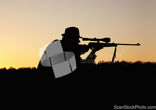Image of Hunting, sunset, man with gun and focus on target in nature to hunt game for sport on safari adventure. Sky, silhouette and hunter with rifle in bush, setting sun and shooting hobby on summer evening
