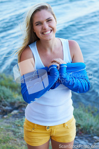 Image of Woman, portrait and smile with wetsuit, ready and happiness for water sports by river, lake or dam. Girl, outdoor and happy with aquatic sportswear, freedom and adventure in nature with excited face