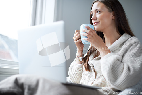 Image of Woman, coffee and laptop for thinking by window with happiness, memory or idea for vision in home. Girl, student and computer with tea cup, relax and brainstorming for learning, education and future