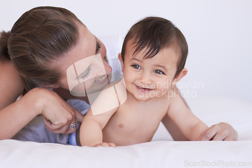 Image of Happy, bedroom and relax baby with mom for morning rest, childhood and enjoy fun bonding time together. Child growth, family happiness and playing mother, mama or woman tickle infant toddler on bed