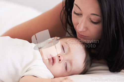 Image of Baby, sleeping and mother in a home bedroom with parent support, care and love. Relax, bed and young girl with mom in a house feeling tired and sleepy with mama rest looking at fatigue of kid