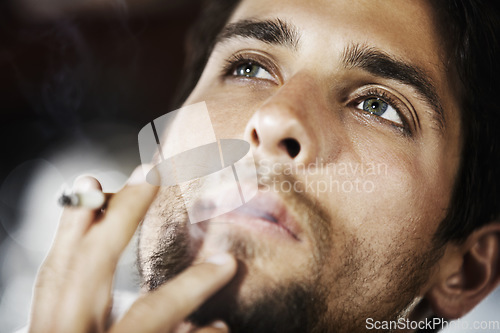 Image of Thinking, smoke and man with a cigarette, ideas and thoughtful with decision, choices and wonder. Male person, human and model smoking, thoughts and cannabis with a guy, break and relax with fantasy